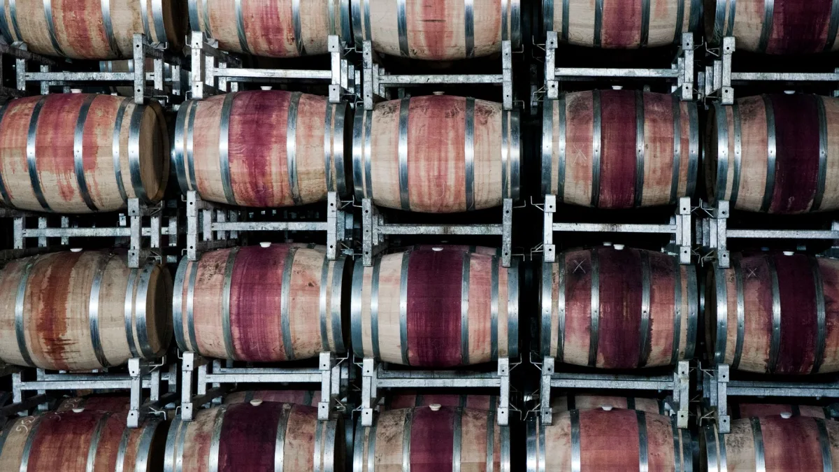 Tonneaux de vin en bois empilés dans une cave, illustrant un domaine viticole cherchant à vendre son vin en ligne dans le Tarn, illustration d'un article du blog d'EPREYN, développeur d'applications et de sites web dans le Tarn